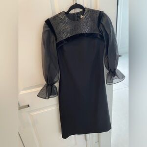 Shanis black long sleeve knee length dress. Poof detail at cuff.